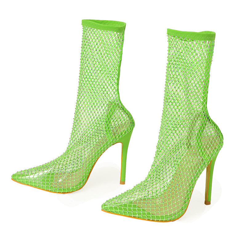 Neon green fishnet high-heeled boots on a white background